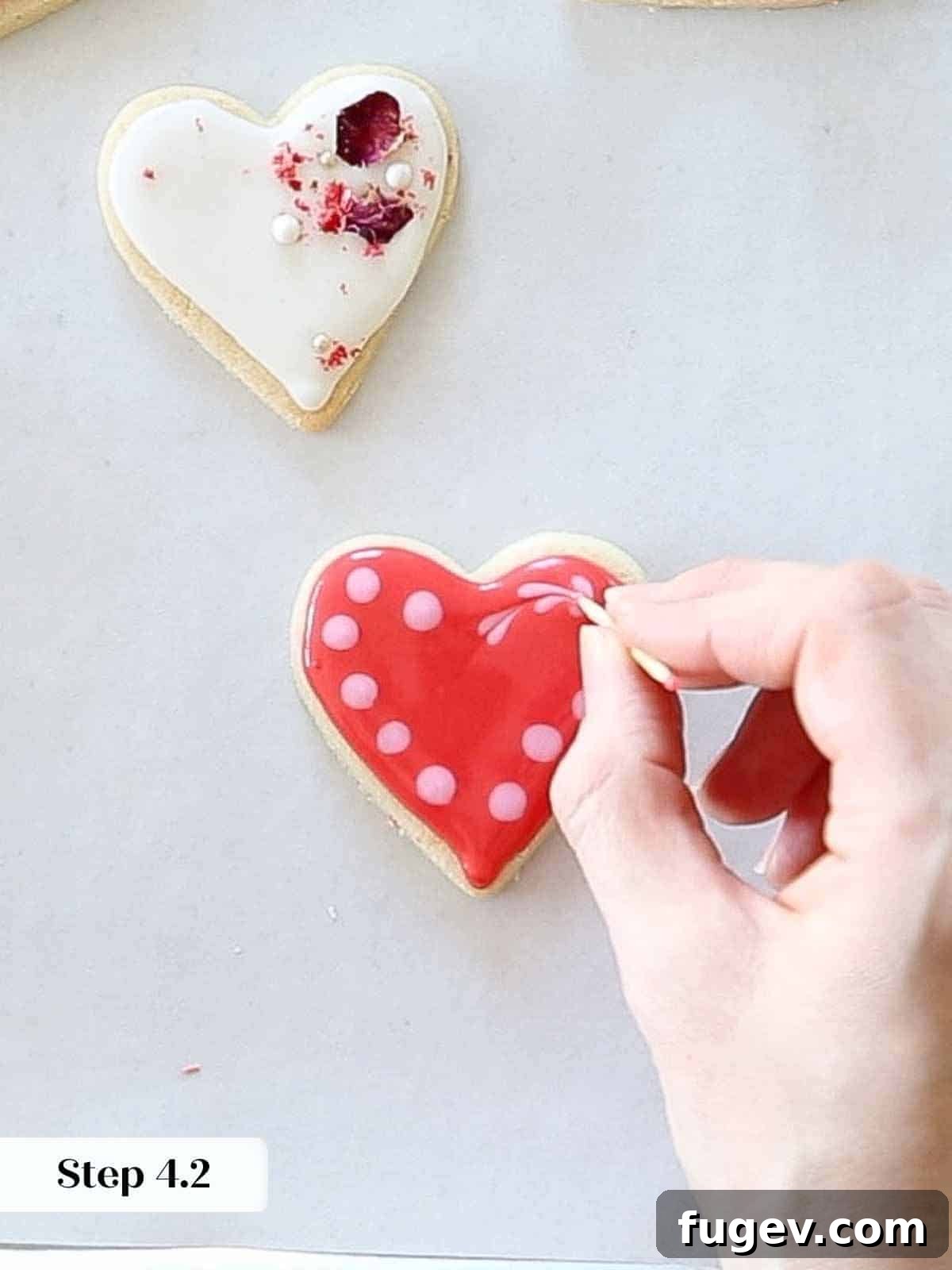 Decadent Chocolate Sugar Delights 9 pink dots on red royal icing making hearts with toothpick.