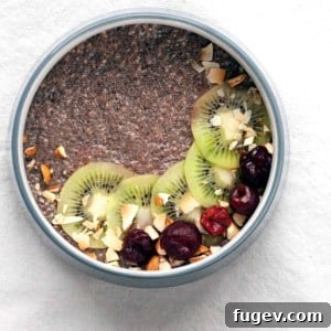 A close-up of Cherry Chia Pudding in a glass jar, showing its creamy texture and vibrant color.