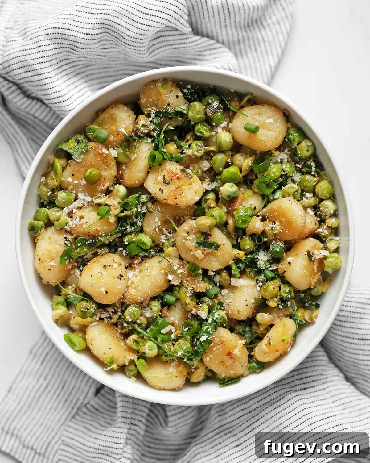 Golden Gnocchi with Bursting Spring Peas 2 Spring gnocchi with smashed peas in a bowl.