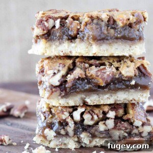 Pecan pie bars stacked on a rustic wooden surface with a warm brown background.