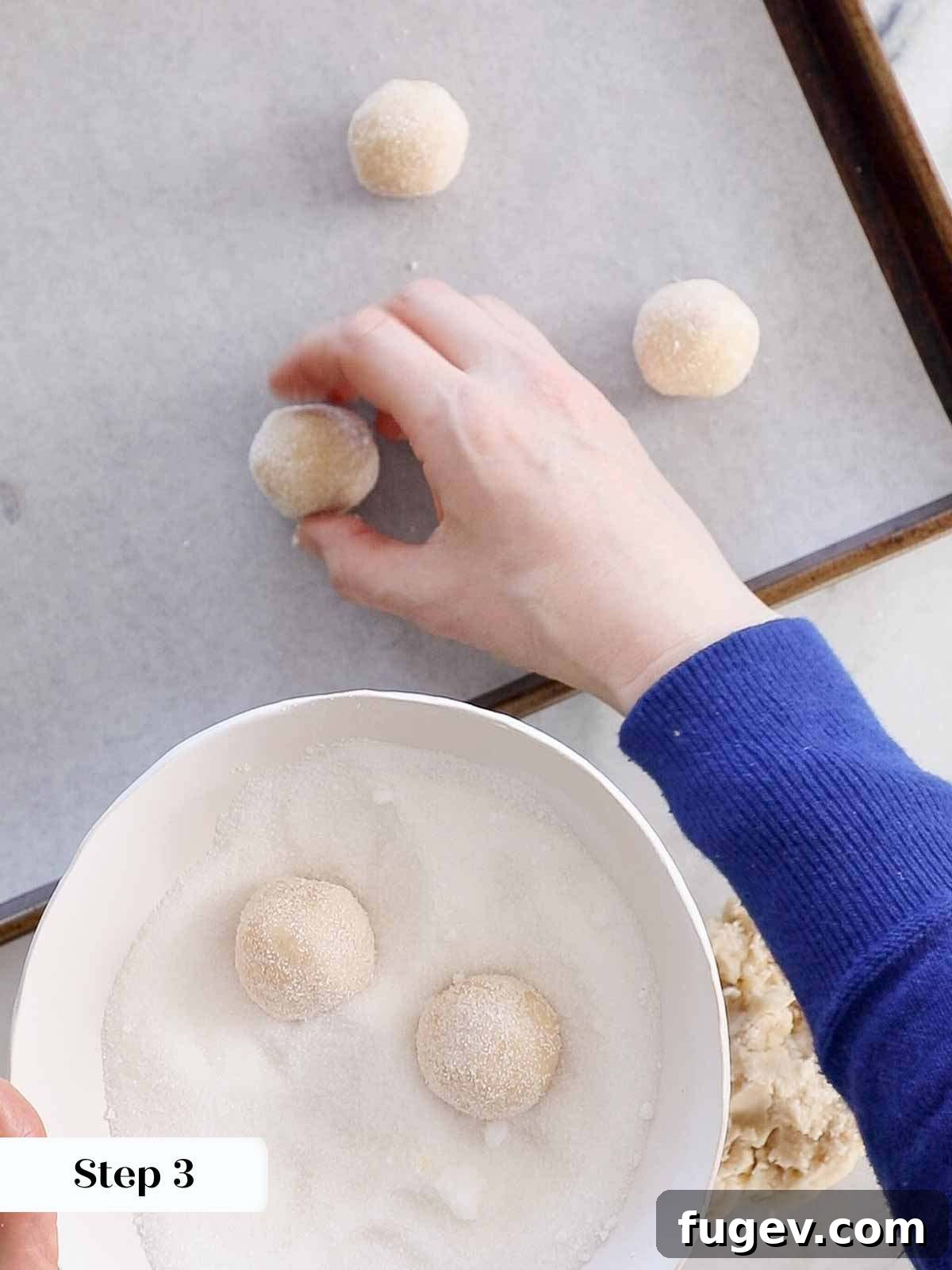 Perfectly Jammed Thumbprints 7 A sequence showing cookie dough balls being rolled in granulated sugar, then placed onto a parchment-lined baking sheet, demonstrating the preparation steps before indentation.
