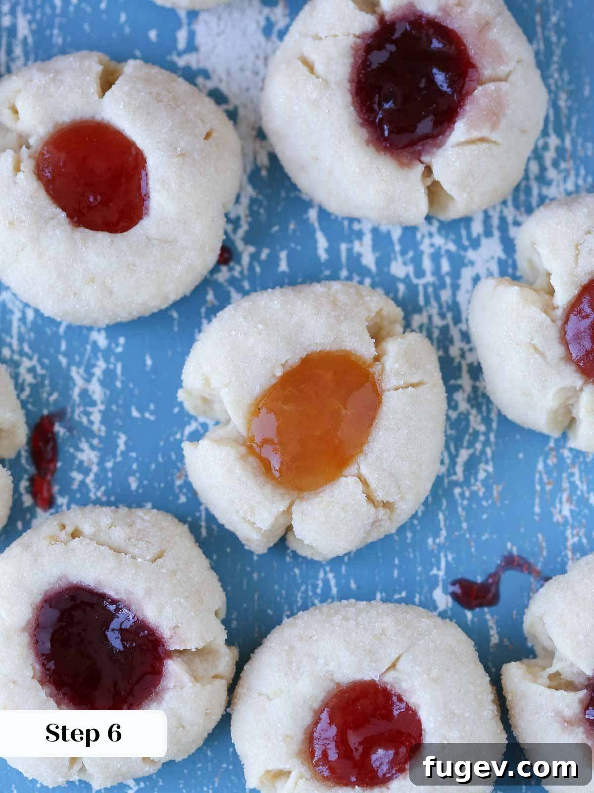 Perfectly Jammed Thumbprints 10 A freshly baked batch of thumbprint cookies cooling on a wire rack, their jam centers glistening and edges lightly golden, signifying readiness for enjoyment.