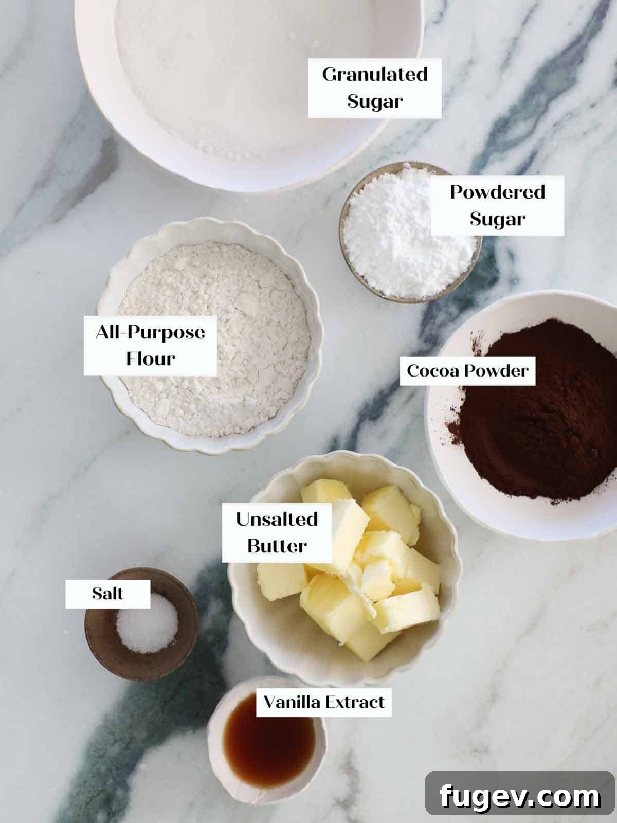 Velvety Chocolate Thumbprint Wonders 4 Key dry ingredients for chocolate thumbprint cookies, including flour, cocoa powder, and powdered sugar, alongside butter and vanilla extract.