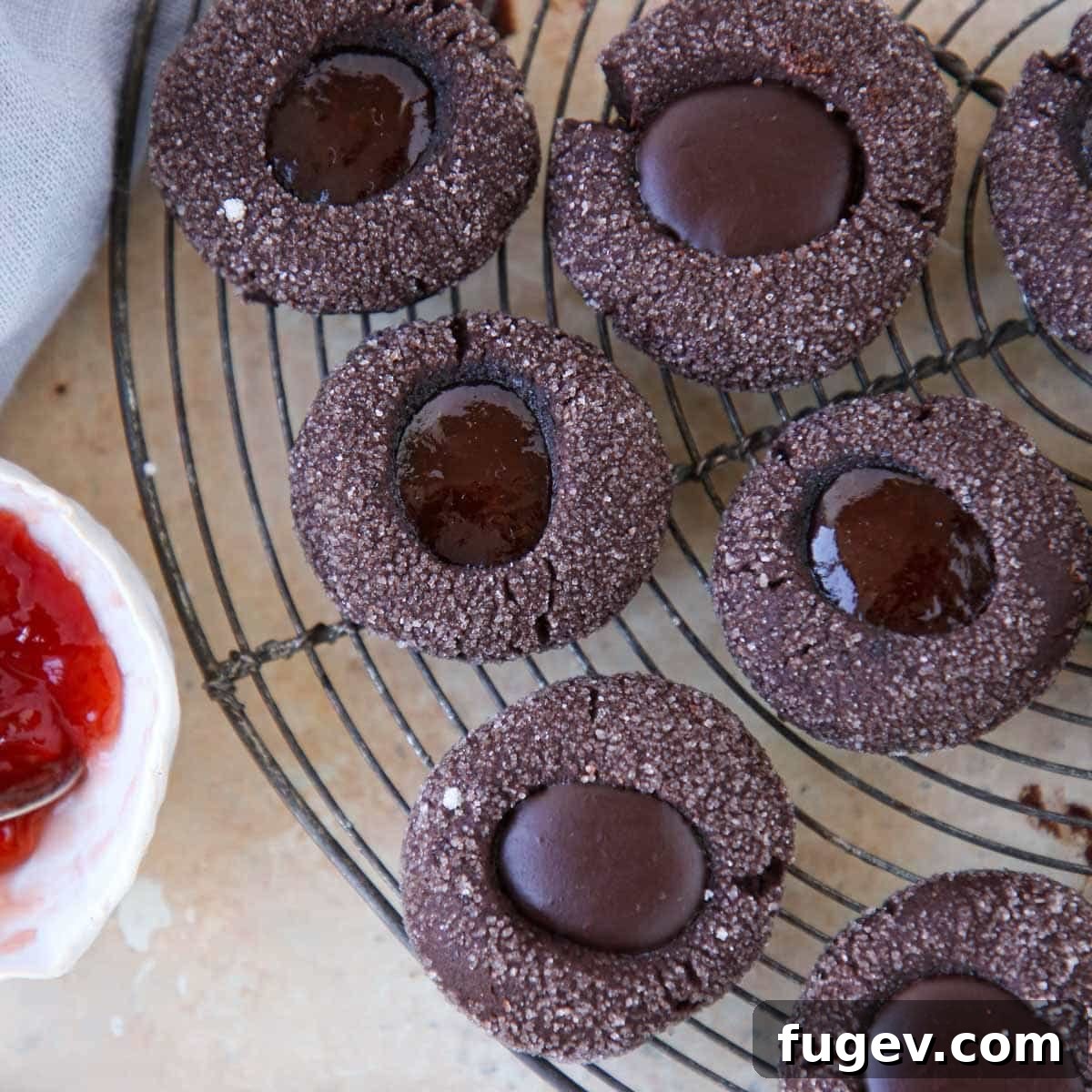 Velvety Chocolate Thumbprint Wonders 6 Freshly baked chocolate thumbprint cookies cooling on a wire rack, waiting to be filled.