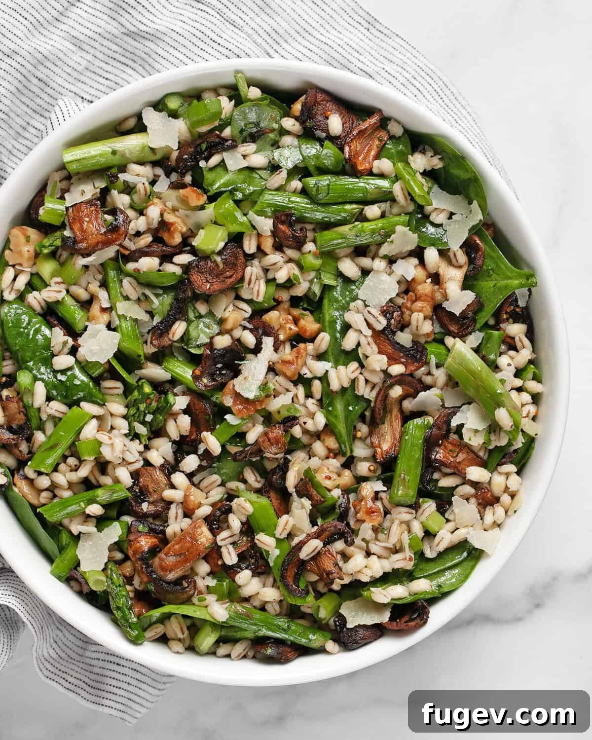 Roasted Asparagus Mushroom Barley Harvest Salad 2 A beautifully presented bowl of roasted asparagus mushroom barley salad, tossed with fresh greens and a bright vinaigrette, ready to serve.