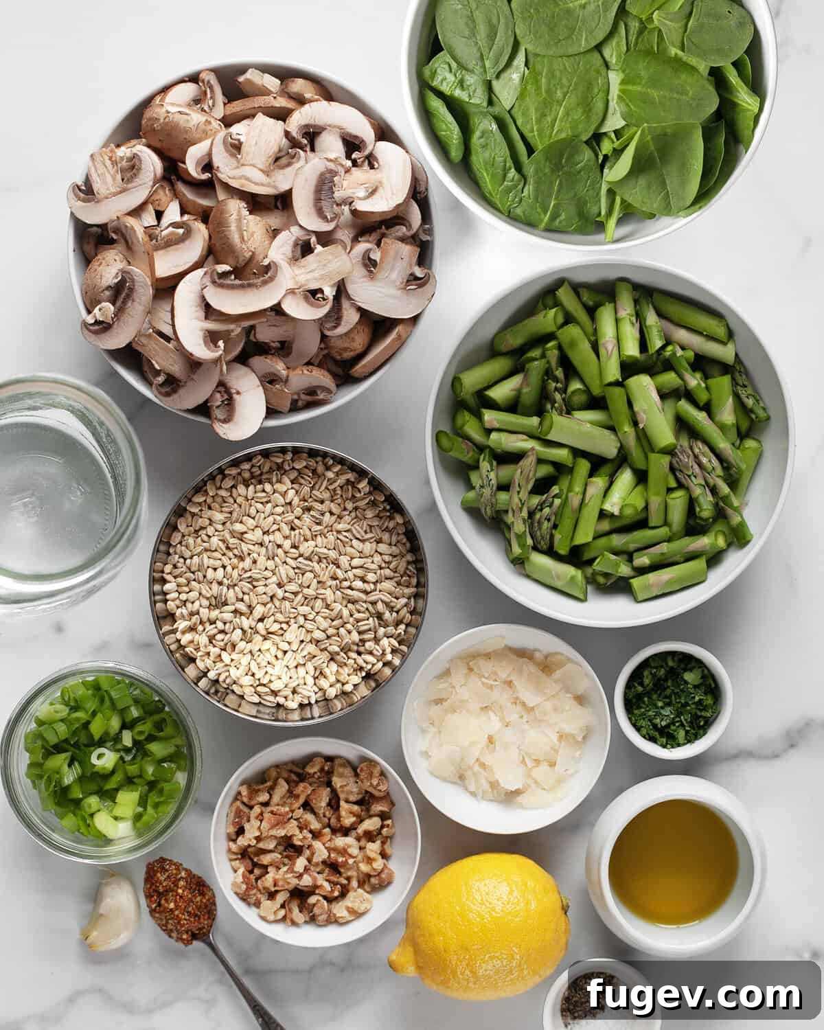 Roasted Asparagus Mushroom Barley Harvest Salad 3 A curated display of fresh ingredients including vibrant green asparagus, sliced cremini mushrooms, pearl barley, lemon, spinach, and walnuts, ready for the recipe.