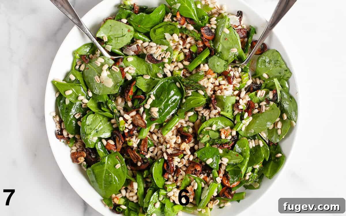 Roasted Asparagus Mushroom Barley Harvest Salad 7 A close-up view of the fully assembled roasted asparagus mushroom barley salad, perfectly tossed in its vinaigrette, in a large mixing bowl.