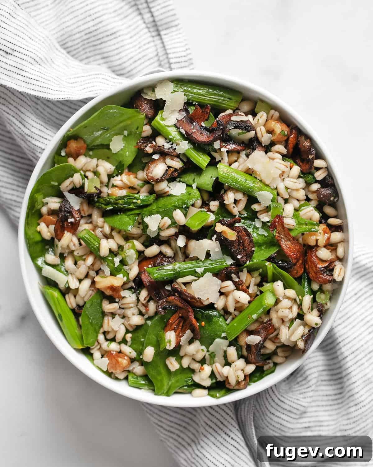 Roasted Asparagus Mushroom Barley Harvest Salad 8 A close-up shot of the finished barley salad with roasted asparagus and mushrooms, presented in an elegant bowl, ready to be enjoyed.