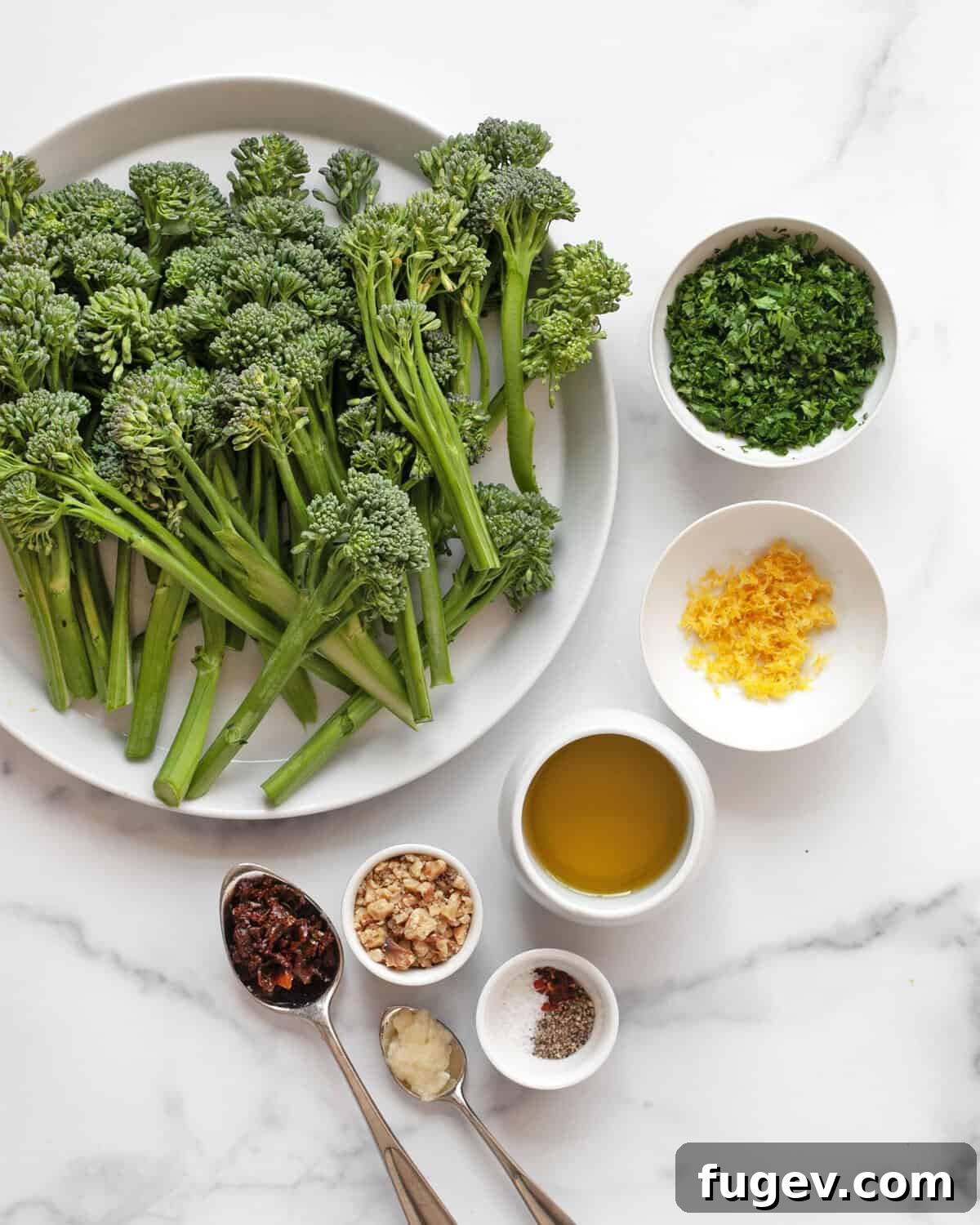 Crisp Roasted Broccolini with Sun Kissed Tomato Gremolata 3 A collection of fresh ingredients for roasted broccolini and gremolata, including broccolini, parsley, lemon, garlic, walnuts, sun-dried tomatoes, olive oil, salt, pepper, and red pepper flakes.