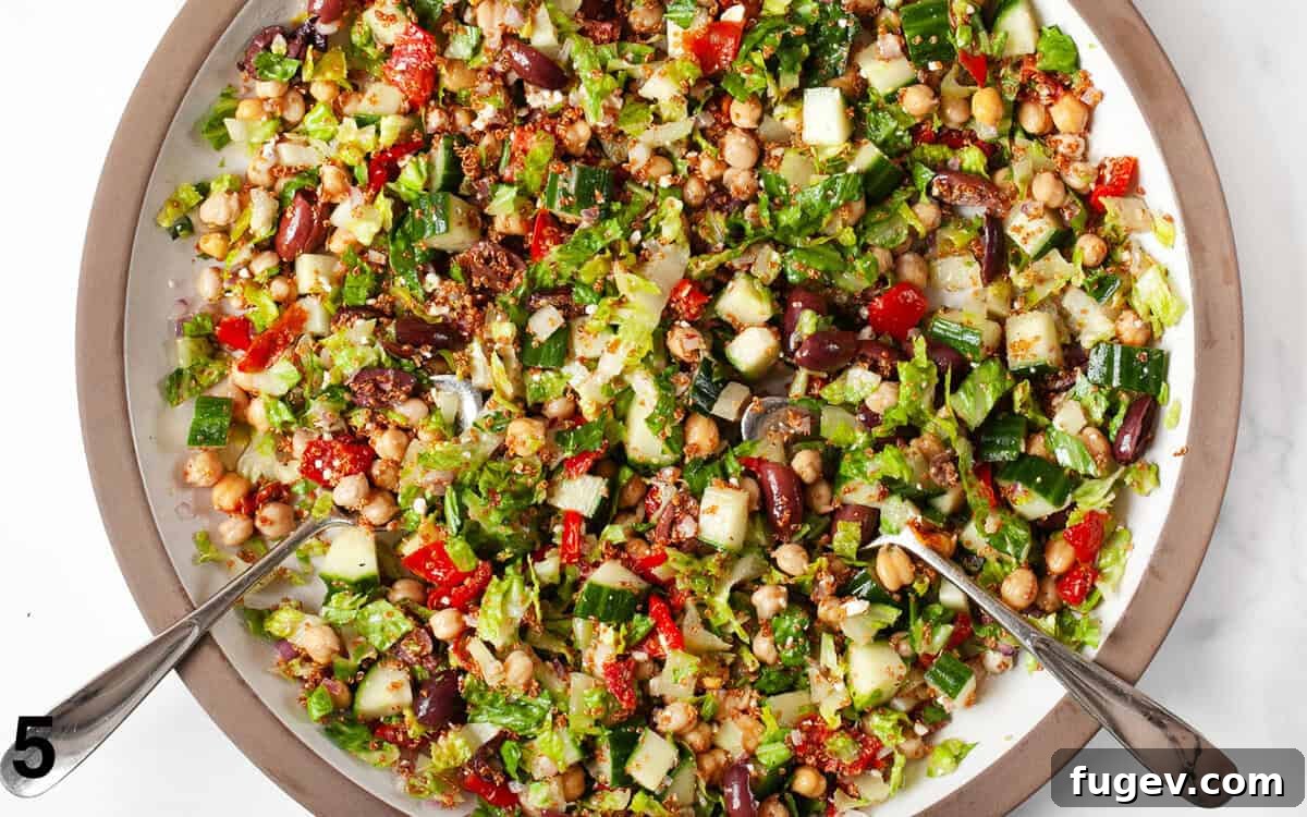 Golden Quinoa Mediterranean Delight 6 Generous Mediterranean salad tossed in a large mixing bowl with crispy quinoa.