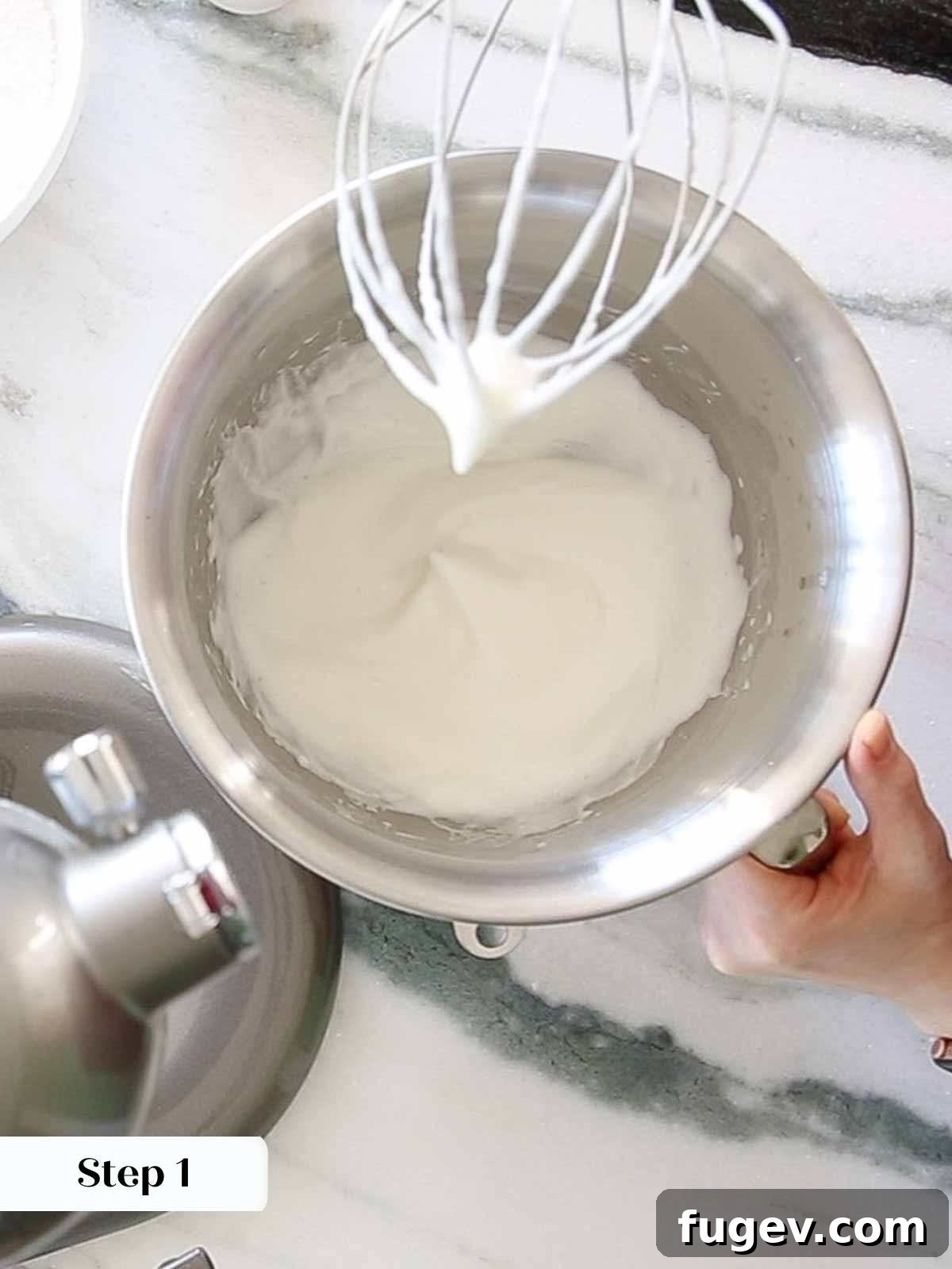 Foolproof Royal Icing with Meringue Powder 7 Close-up of meringue powder and lemon juice whipped to perfect soft peaks in a mixing bowl, ready for the next step.