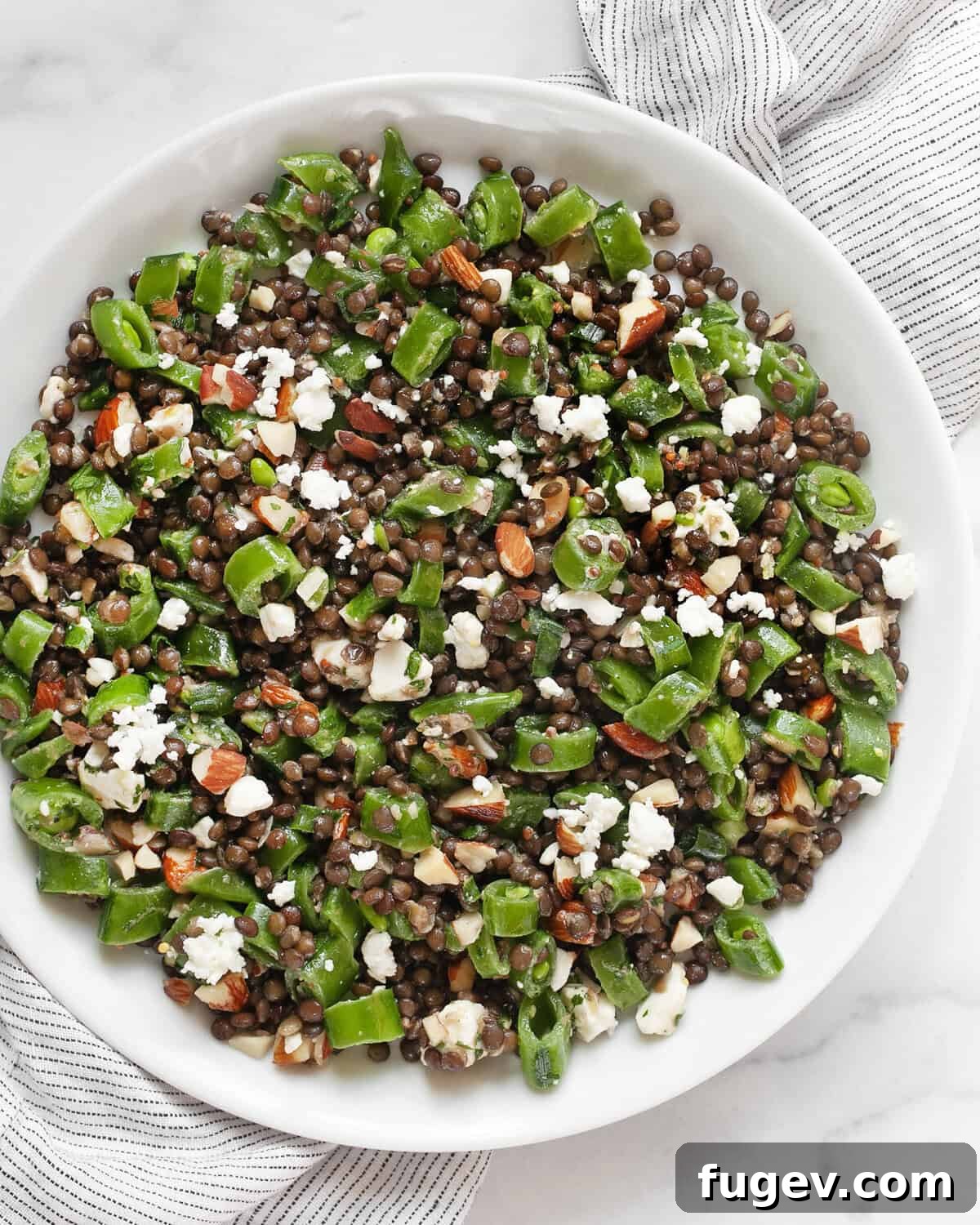 Crunchy Snap Pea and Lentil Delight 6 A serving of snap pea lentil salad plated beautifully, ready to be enjoyed as a meal.