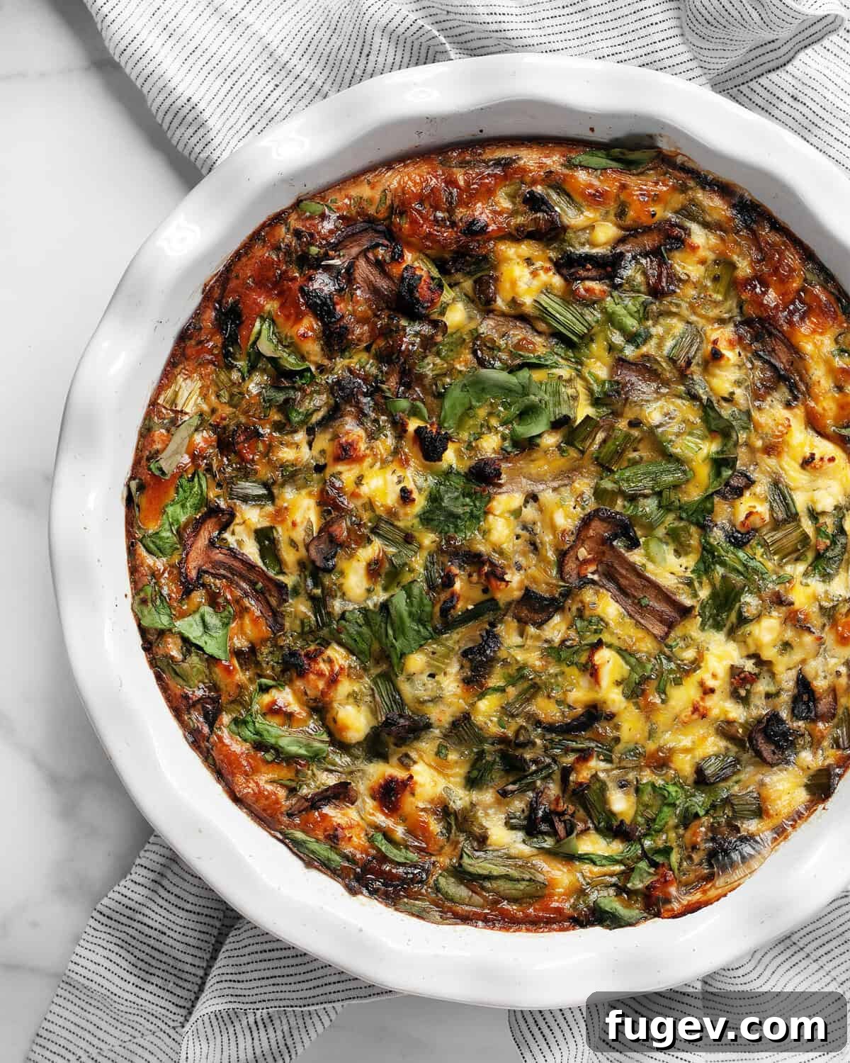 Roasted Asparagus and Creamy Cottage Cheese Frittata 2 A beautifully golden-brown roasted asparagus cottage cheese egg bake, fresh from the oven, served in a classic pie dish.