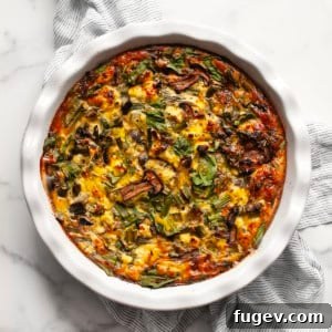 Roasted asparagus cottage cheese egg bake in a pie dish.
