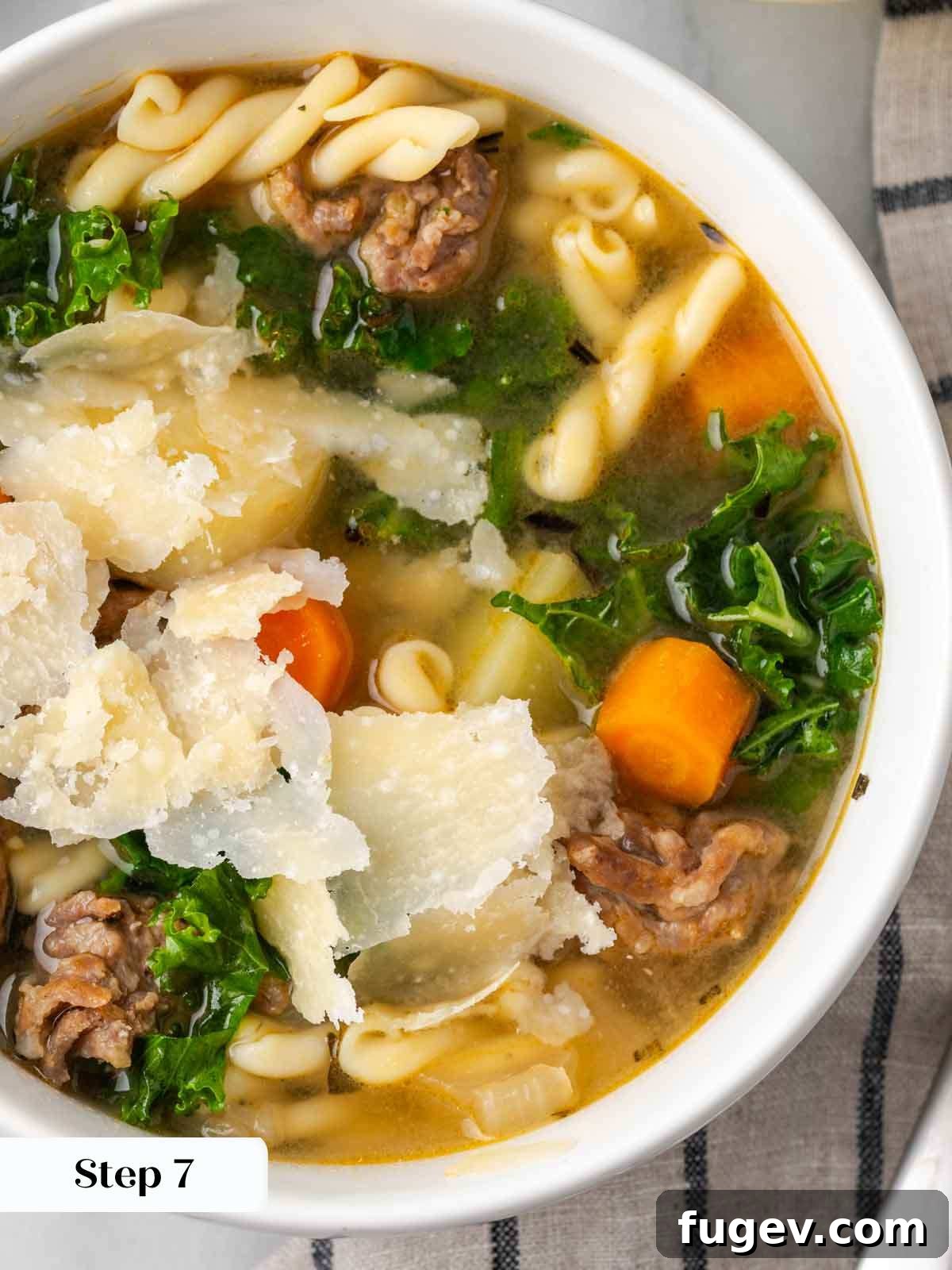 Hearty Italian Sausage Soup 9 A beautifully presented bowl of Italian sausage and vegetable soup, generously garnished with vibrant green kale, ready to be enjoyed.