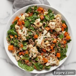 Sweet potato cauliflower salad on a plate with farro.