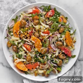 Orange salad with fennel and olives on a plate.