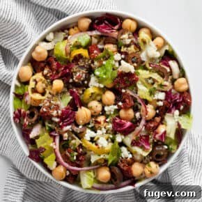 Salad with romaine, radicchio, chickpeas and tomatoes in a bowl.