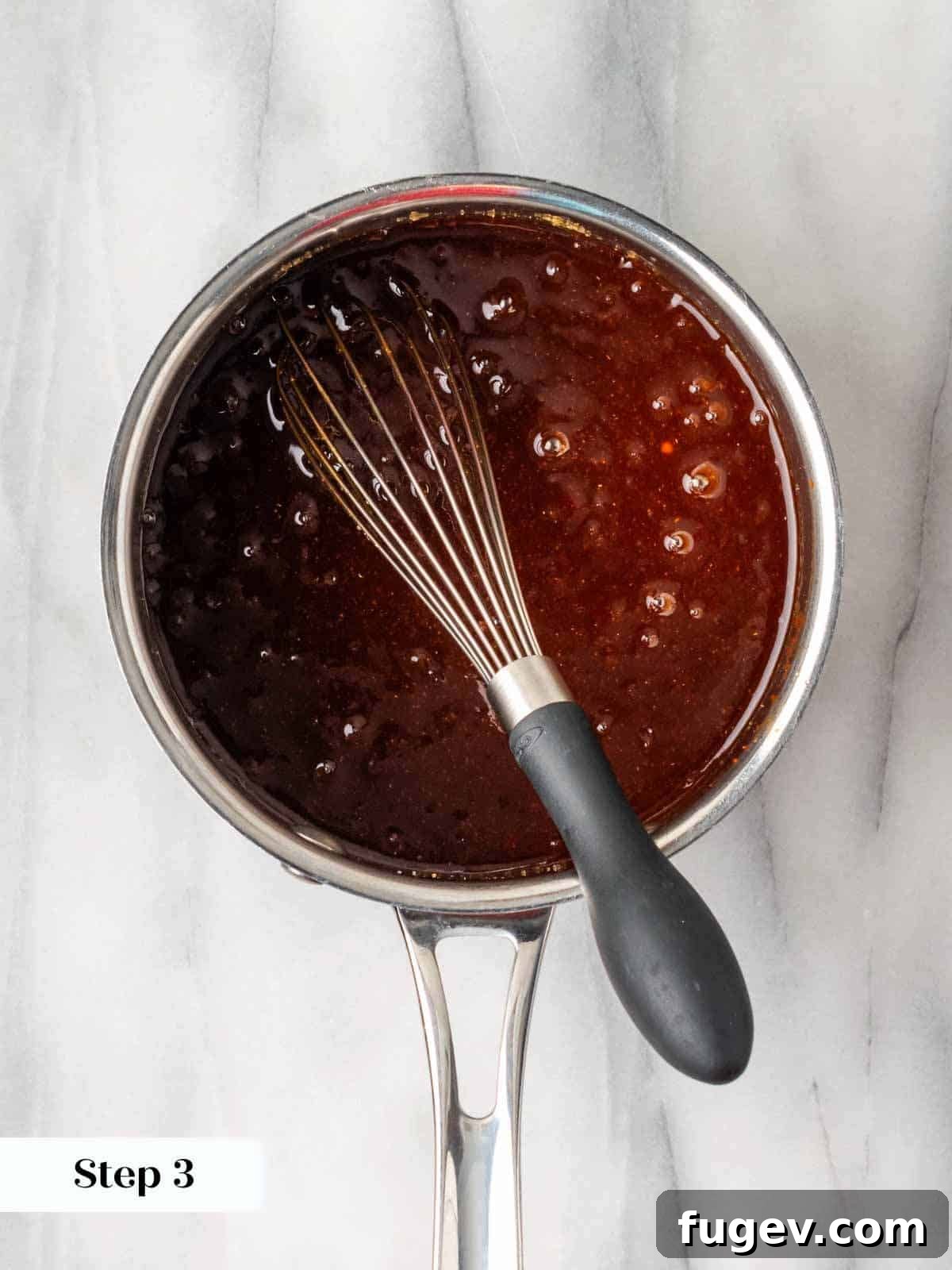 Simple Homemade BBQ Sauce 7 Homemade BBQ sauce boiling gently on the stovetop.
