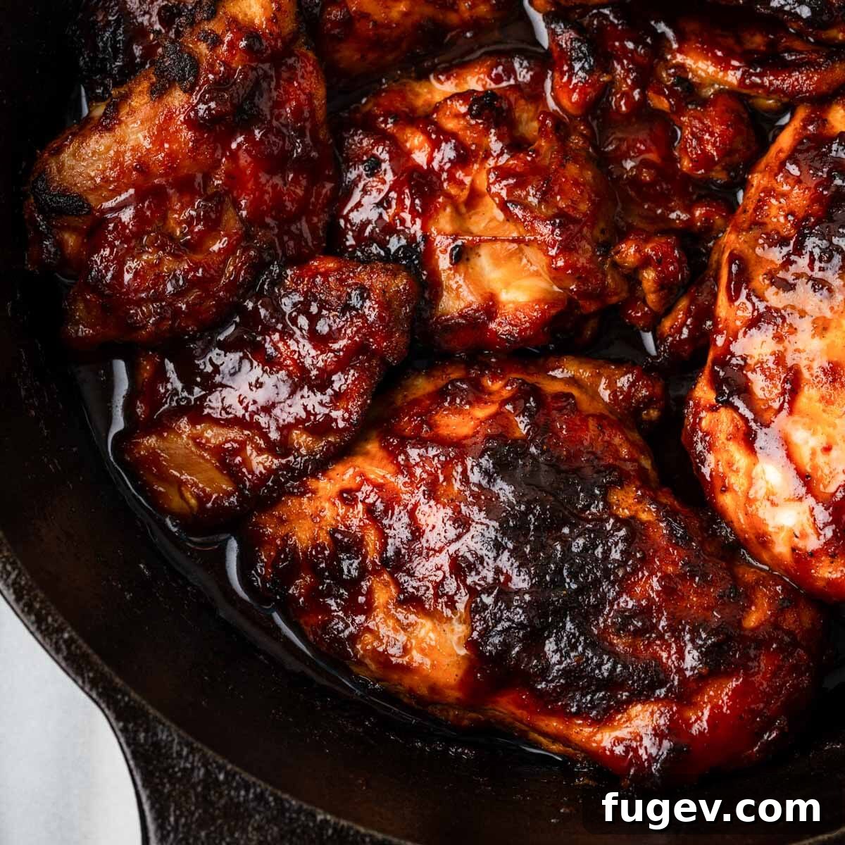 Simple Homemade BBQ Sauce 8 Baked BBQ chicken in a black skillet, perfectly glazed and ready to serve.