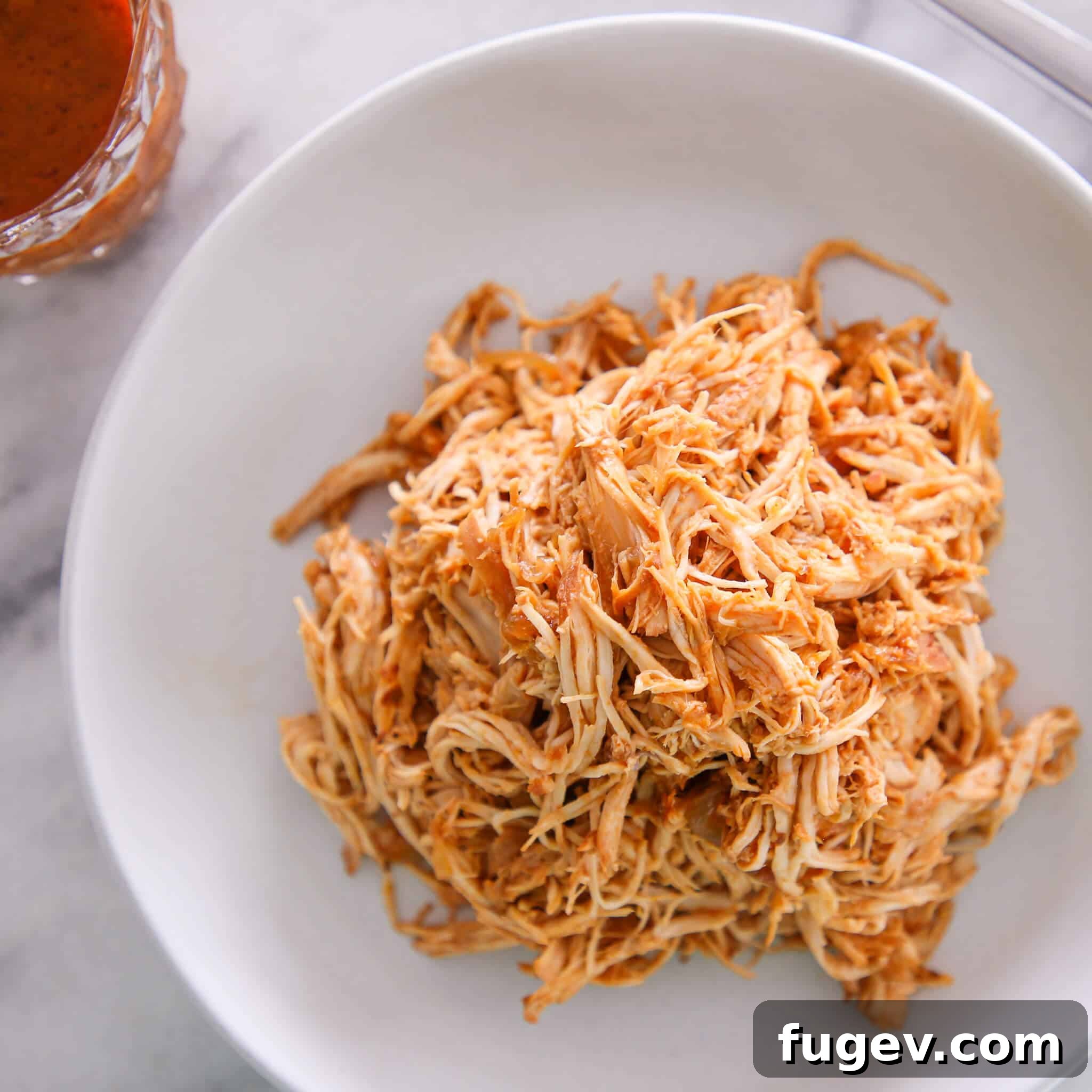 Simple Homemade BBQ Sauce 9 Slow cooker barbecue pulled chicken in a white bowl, ready for sandwiches.