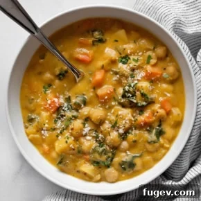 Hearty chickpea soup served in a rustic bowl.