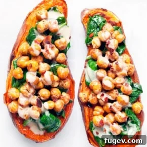 Baked sweet potatoes generously stuffed with crispy chickpeas and sautéed spinach.