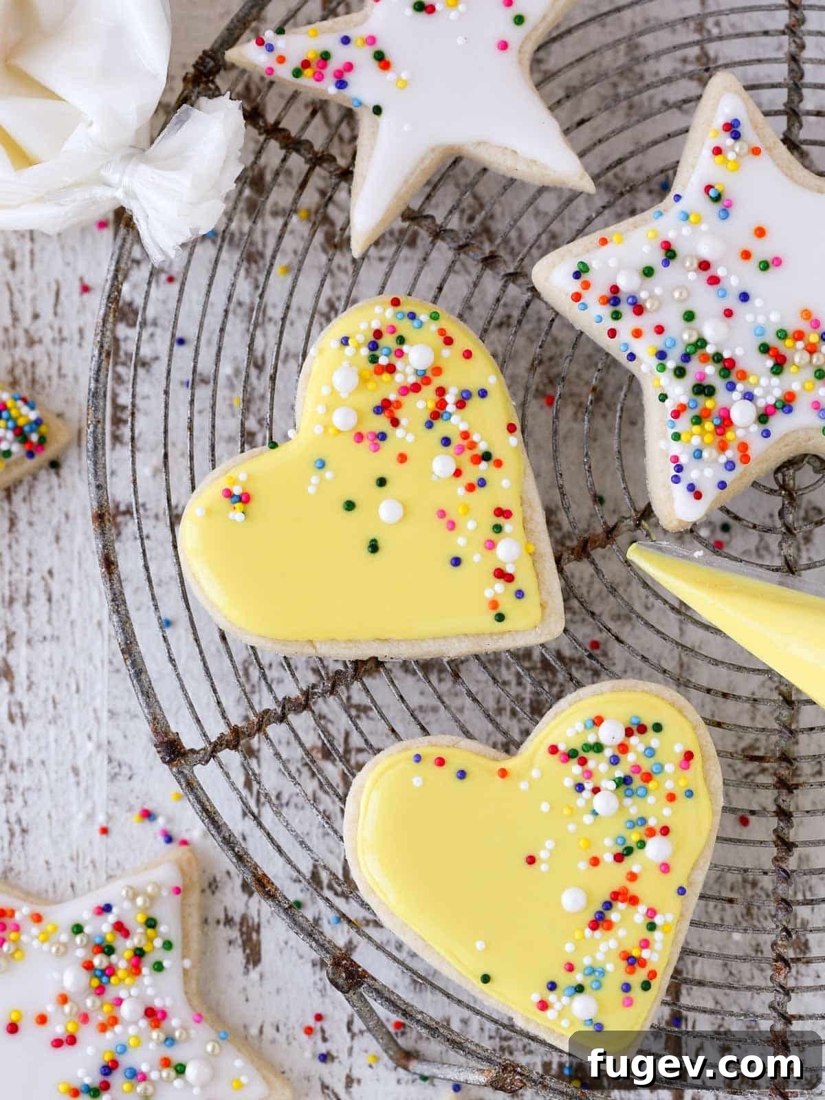 Melt-in-Your-Mouth Sugar Cookies 2 Beautifully decorated soft sugar cookies with white and yellow royal icing.