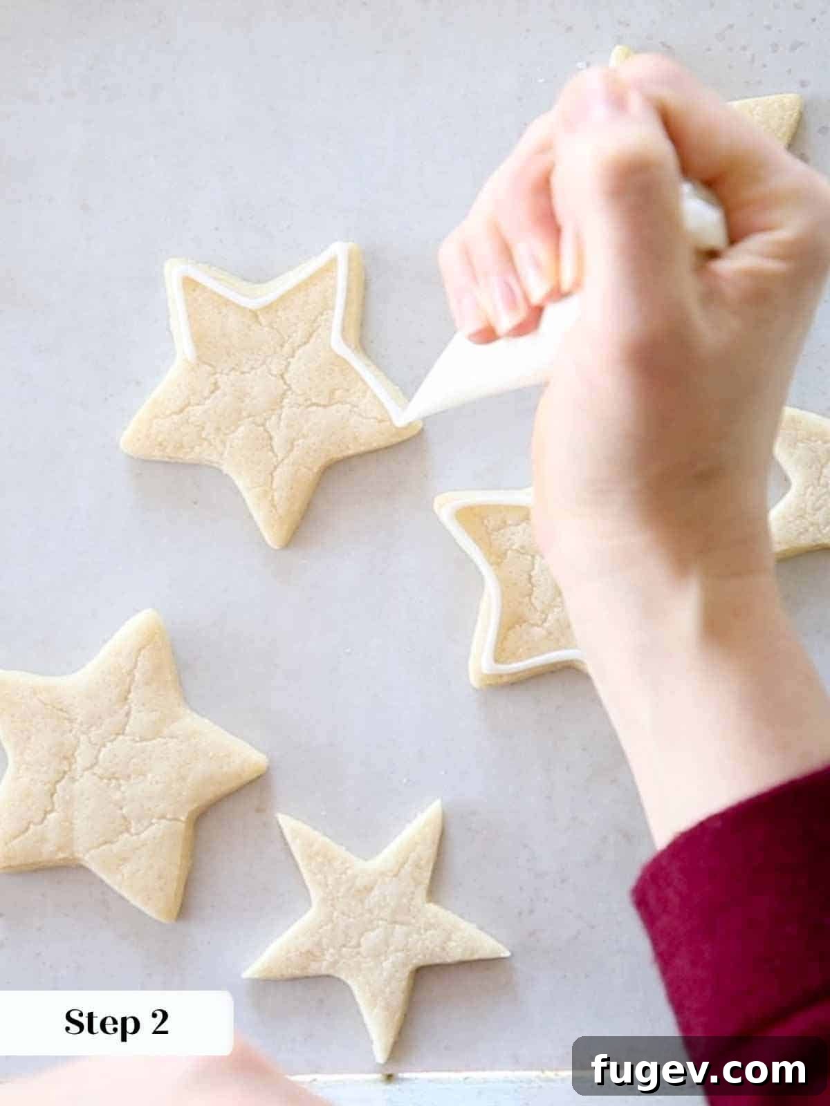 Melt-in-Your-Mouth Sugar Cookies 12 Outlining white royal icing on star-shaped sugar cookies.