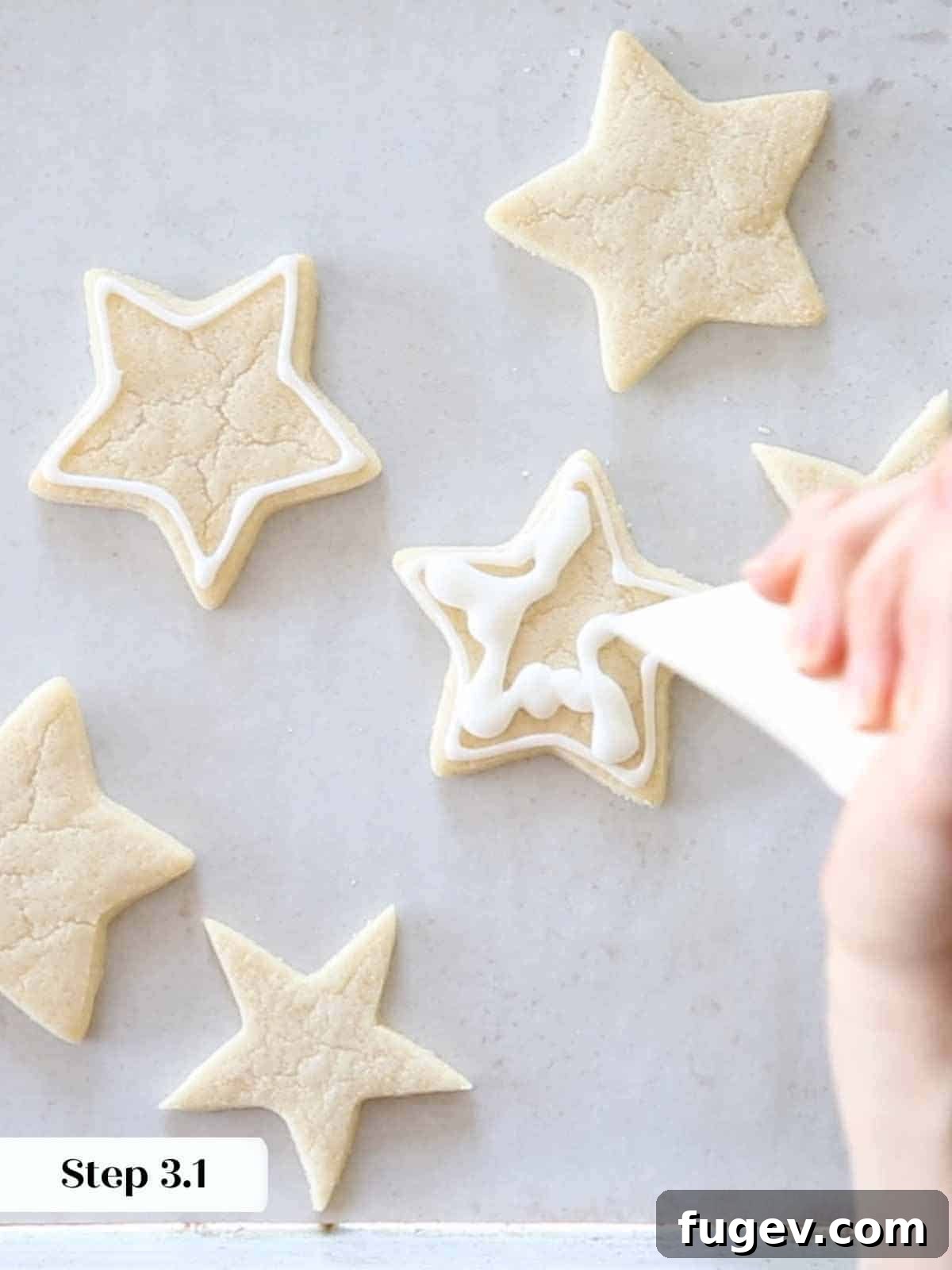 Melt-in-Your-Mouth Sugar Cookies 13 Applying white royal icing in squiggles for flooding on star-shaped sugar cookies.