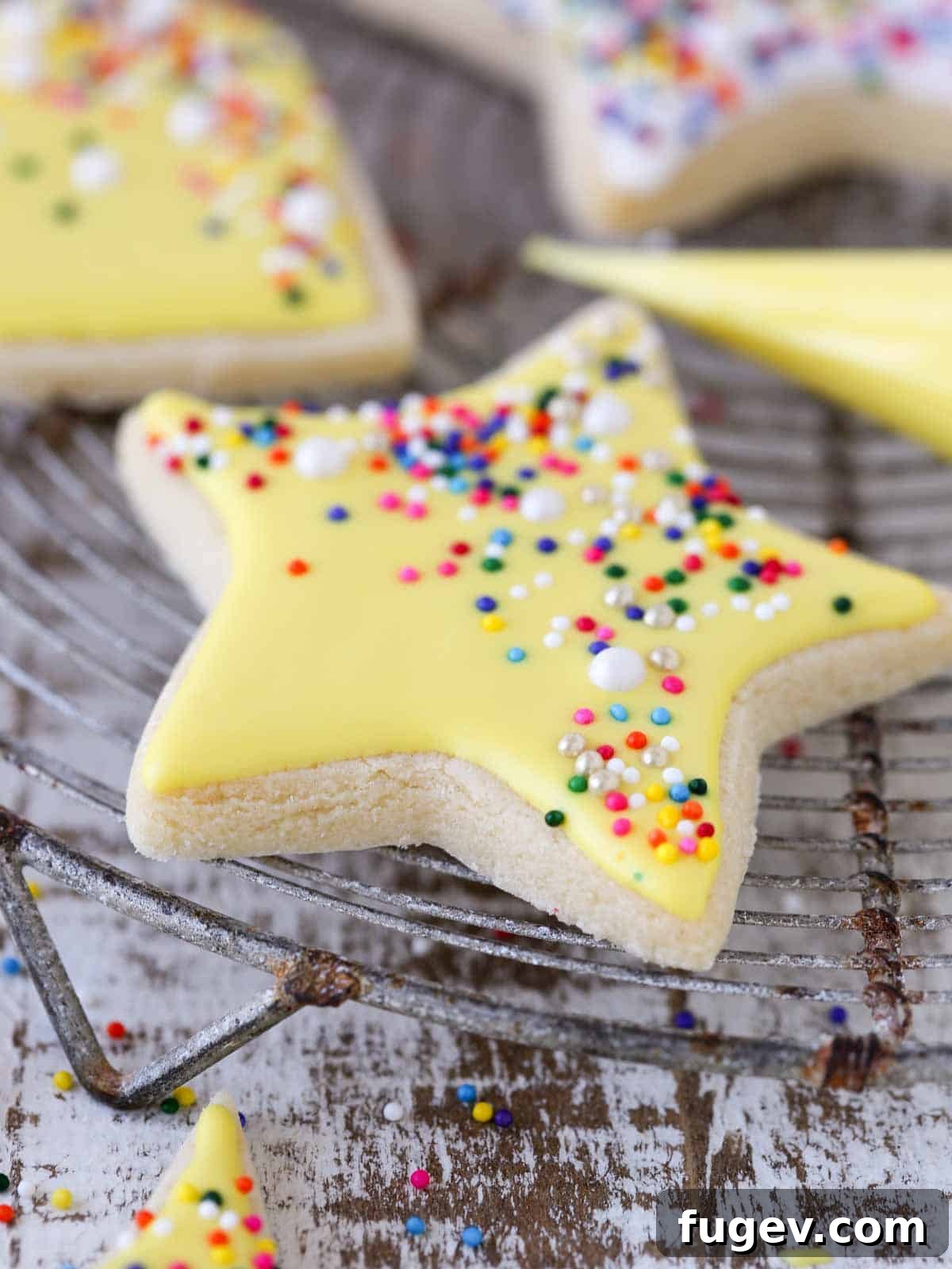 Melt-in-Your-Mouth Sugar Cookies 5 A perfectly baked yellow star-shaped sugar cookie resting on a vintage cake cooling rack.