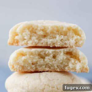 one chewy sugar cookie broken in half and stacked.