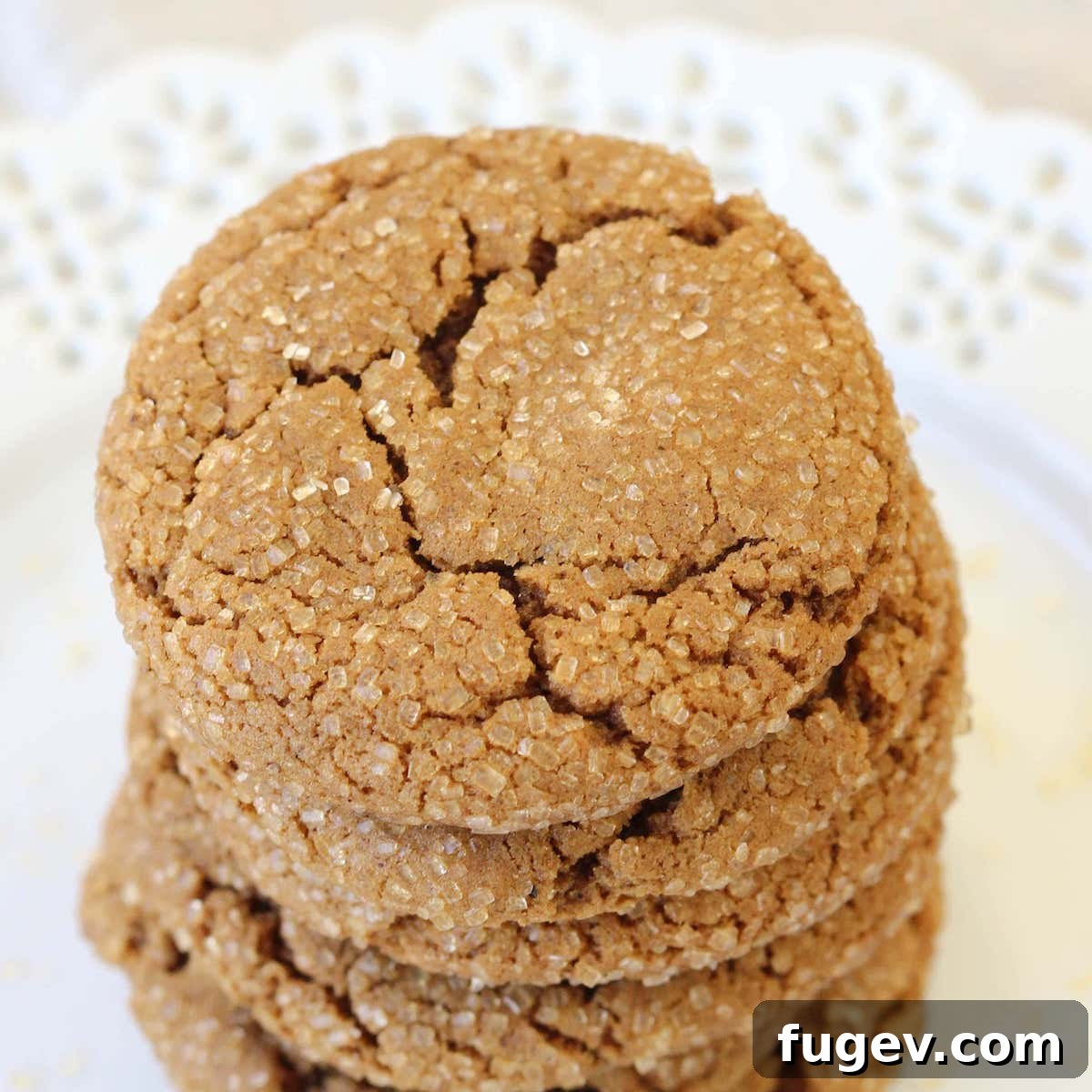 25 Deliciously Simple Christmas Cookies 24 Molasses Spice Cookies stacked on white lace plate.