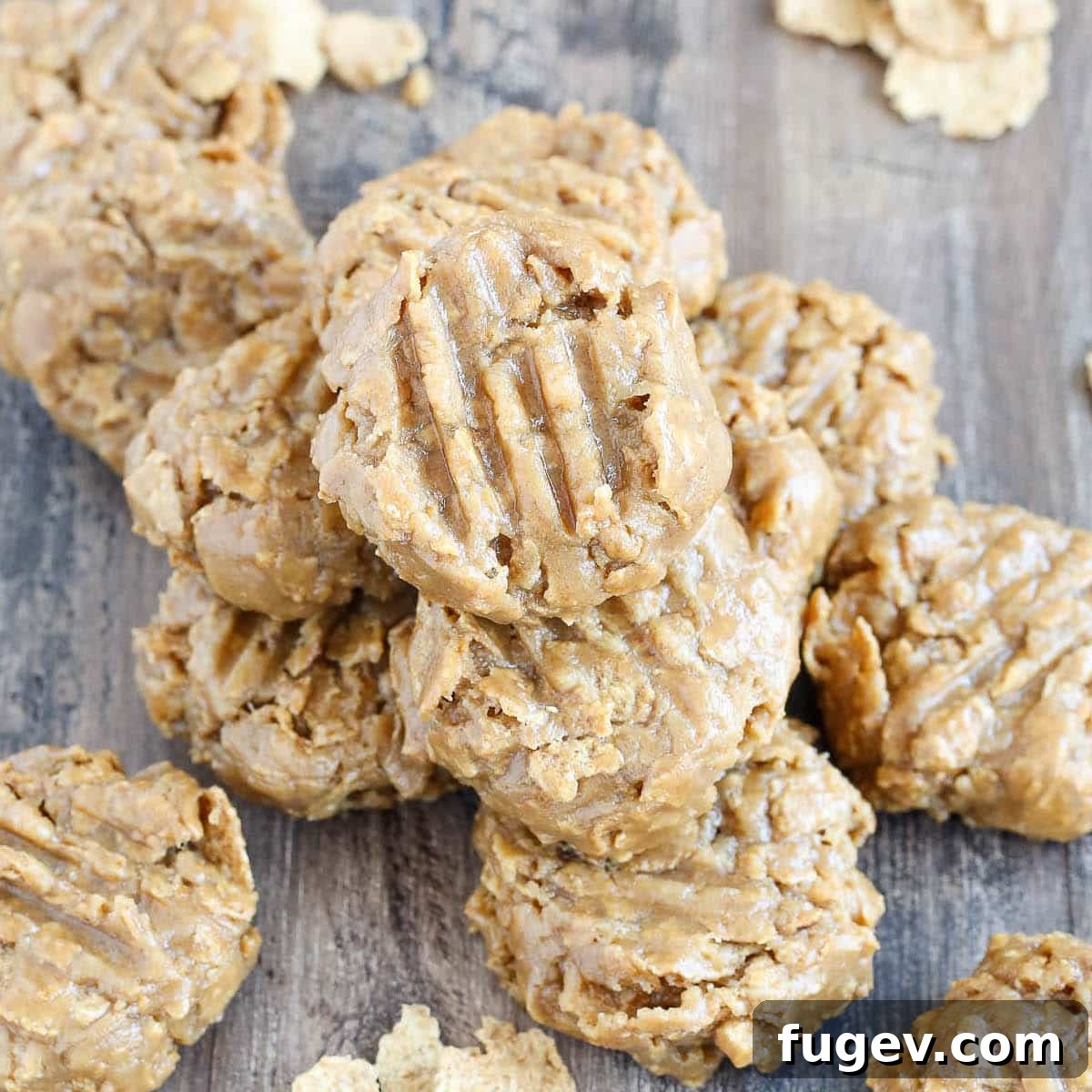 25 Deliciously Simple Christmas Cookies 35 No Bake Peanut Butter Cookies stacked on wooden surface.