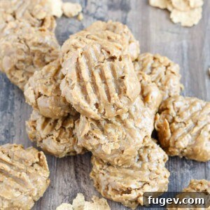 No Bake Peanut Butter Cookies stacked on wooden surface.