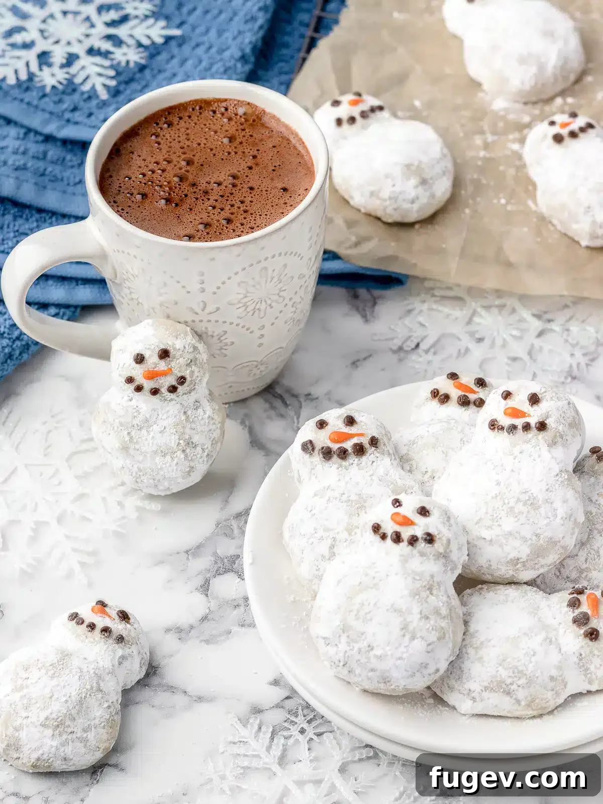 25 Deliciously Simple Christmas Cookies 38 snowman cookies with piped faces.