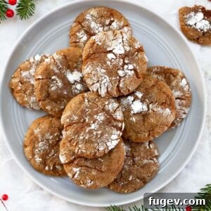 gingerbread crinkle cookies on white plate.