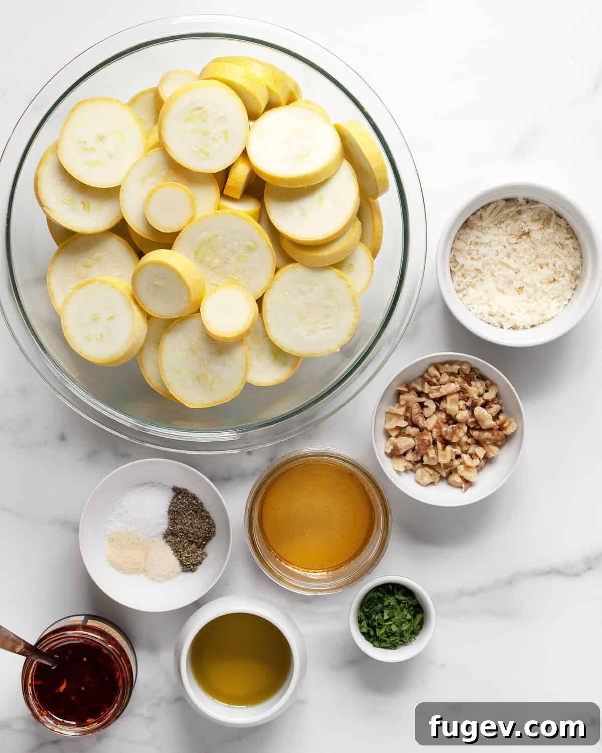 Sweet Heat Parmesan Roasted Squash 3 Ingredients for roasted yellow squash, including sliced yellow squash, grated Parmesan, walnuts, parsley, honey, chili crisp, olive oil, and various dried spices.