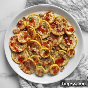 Parmesan roasted yellow squash drizzled with hot honey on a plate.