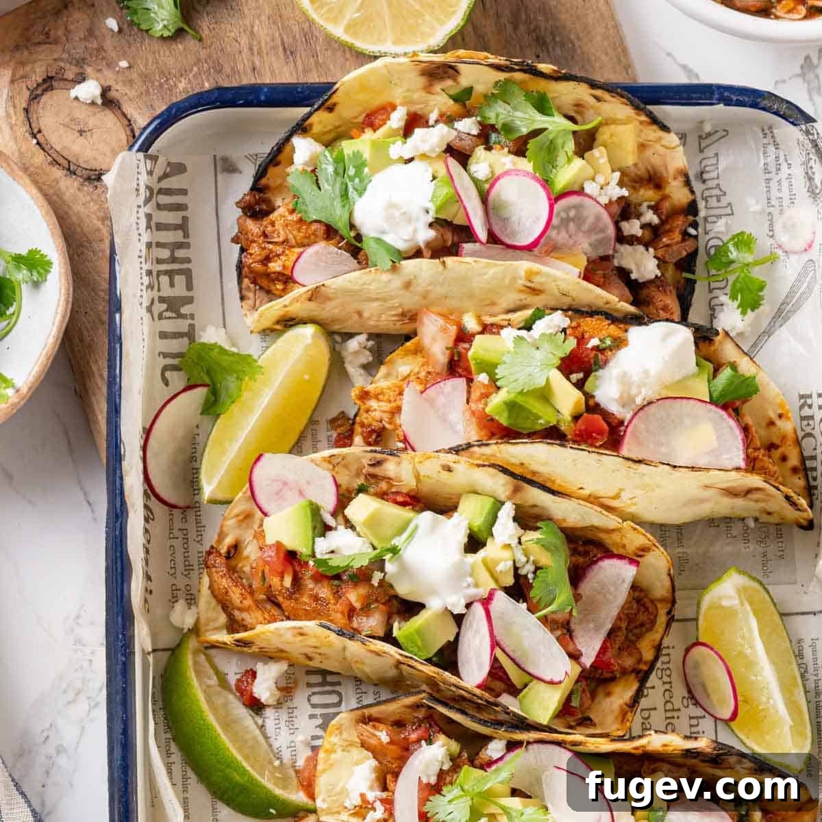 Fiesta Chicken Tacos 3 Freshly prepared chicken tacos adorned with vibrant chopped herbs, ready to be served.