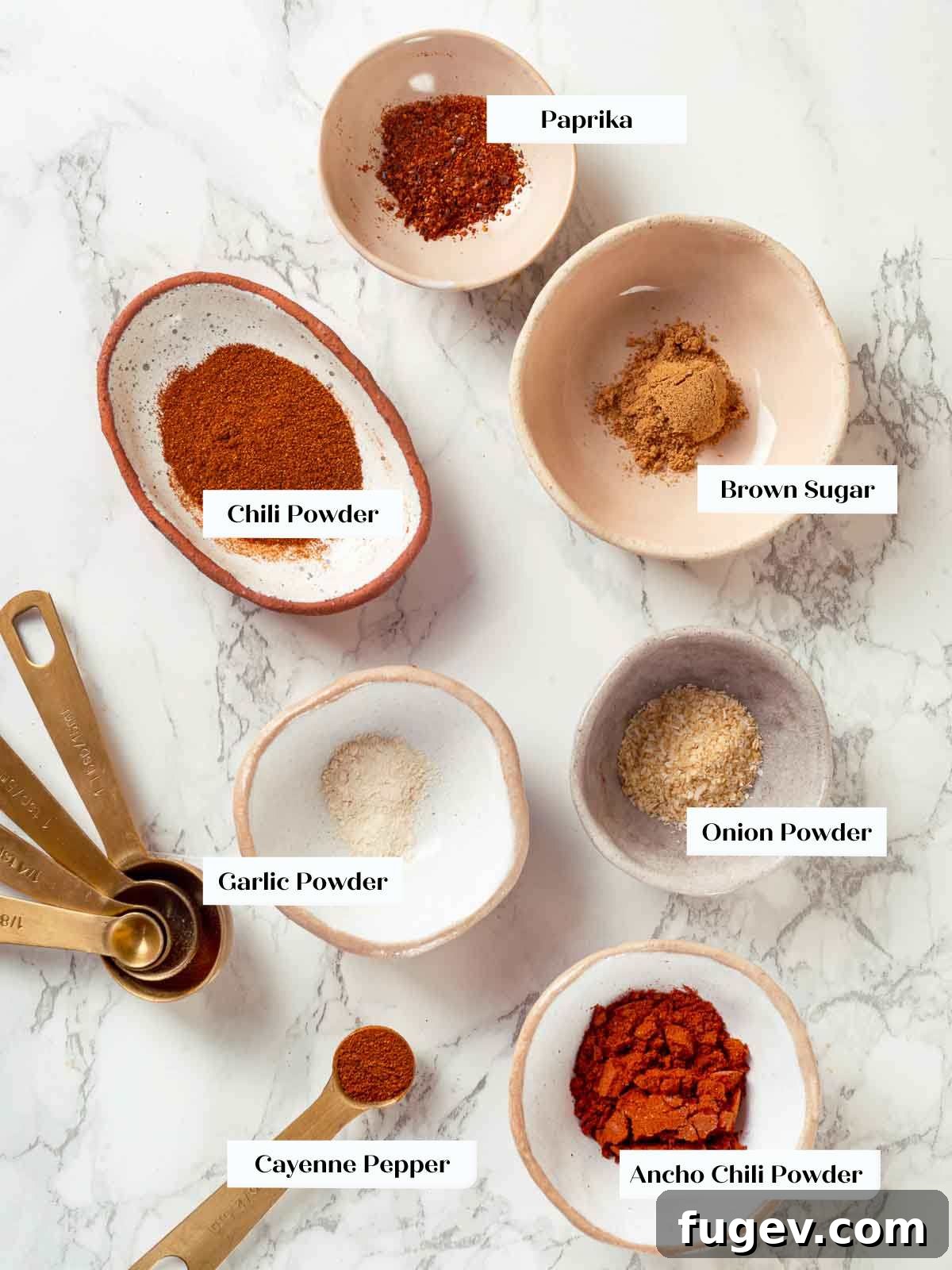 Fiesta Chicken Tacos 4 A collection of spices and ingredients for homemade taco seasoning on a white background.