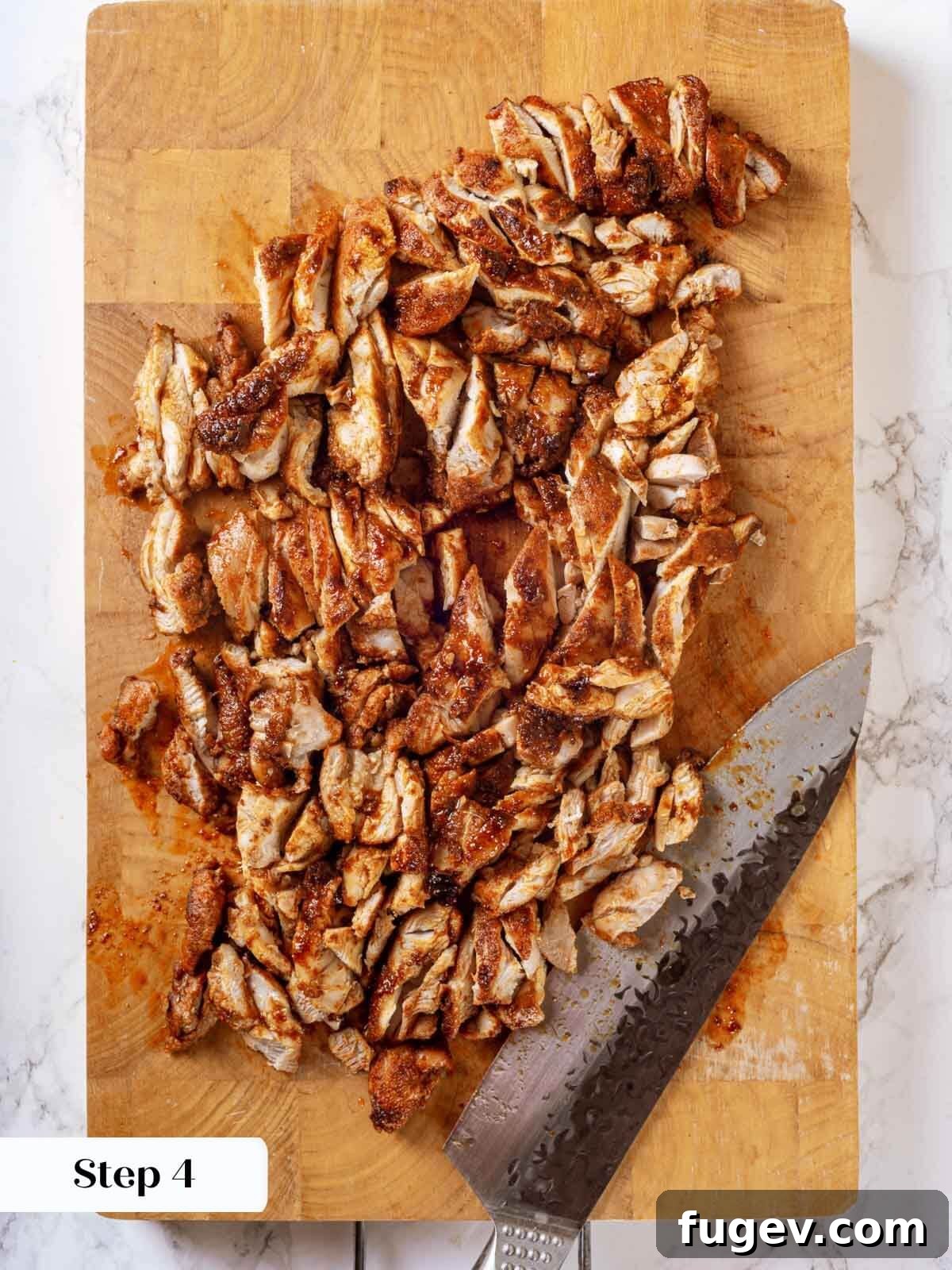 Fiesta Chicken Tacos 9 Cooked chicken resting on a cutting board before chopping.