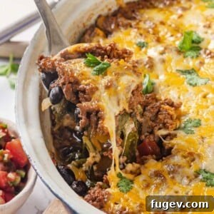 Delicious taco bake with melted cheese being served.
