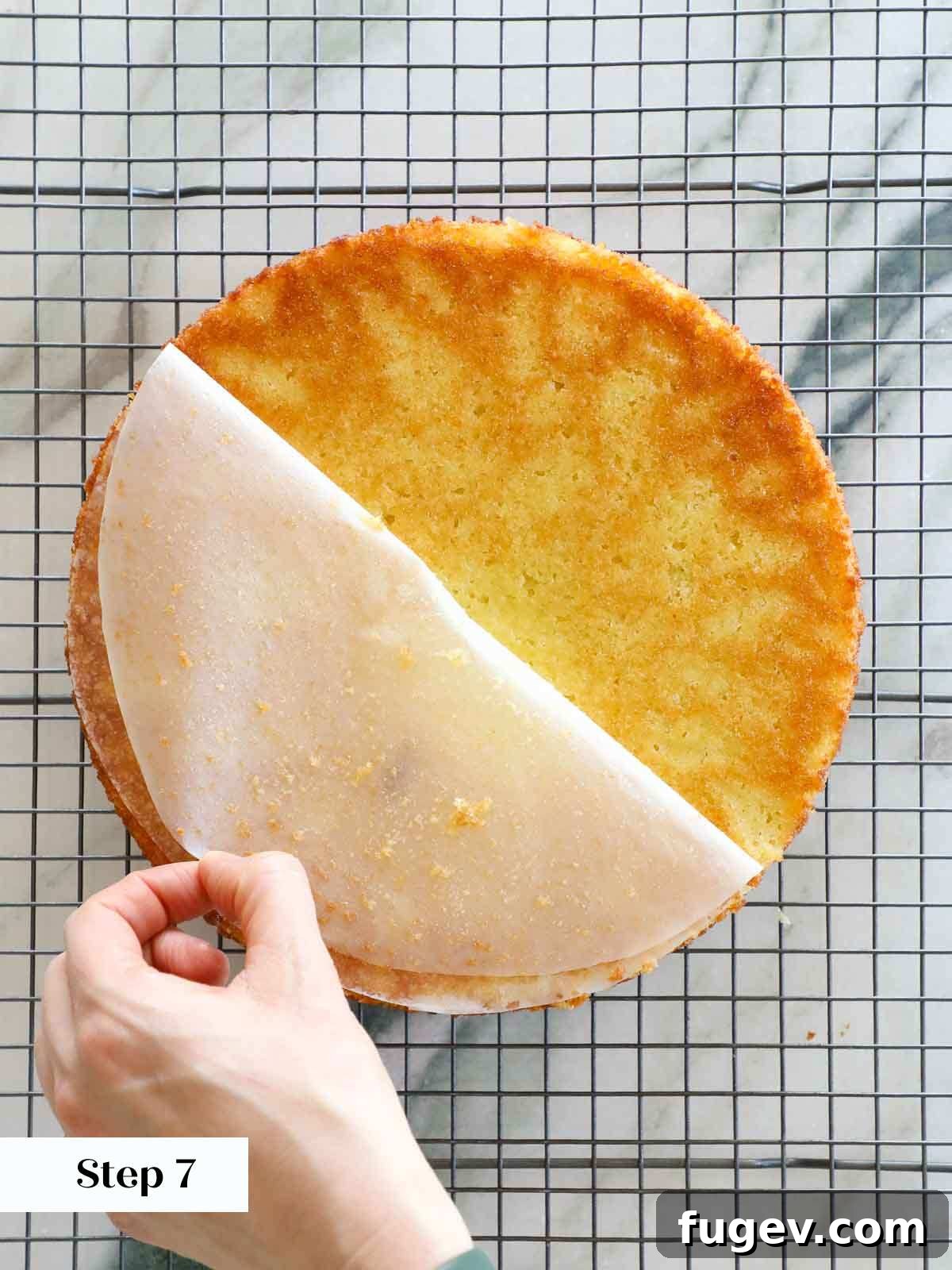 Zesty Mediterranean Olive Oil Cake 11 pealing parchment circle from bottom of cooling cake.