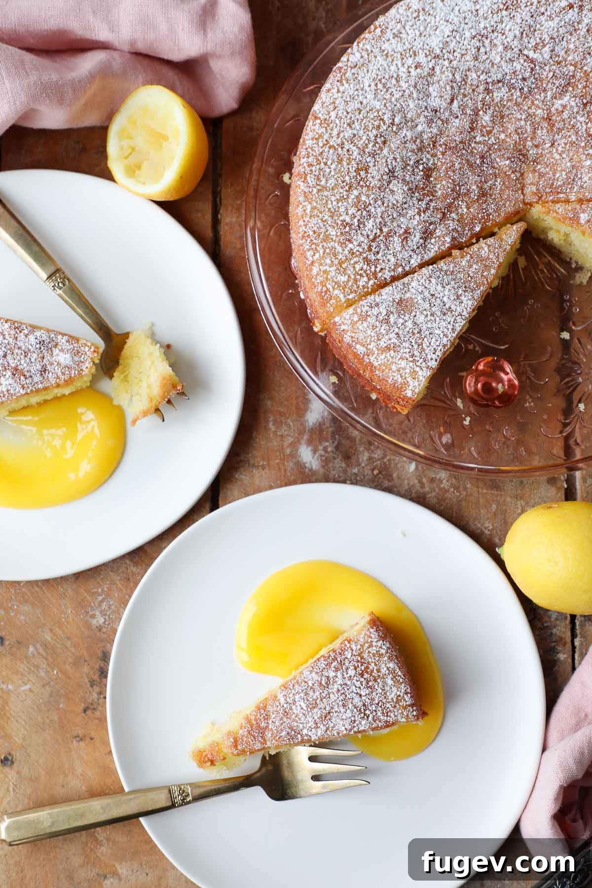 Zesty Mediterranean Olive Oil Cake 3 lemon olive oil cake plated on white plates with lemon curd.