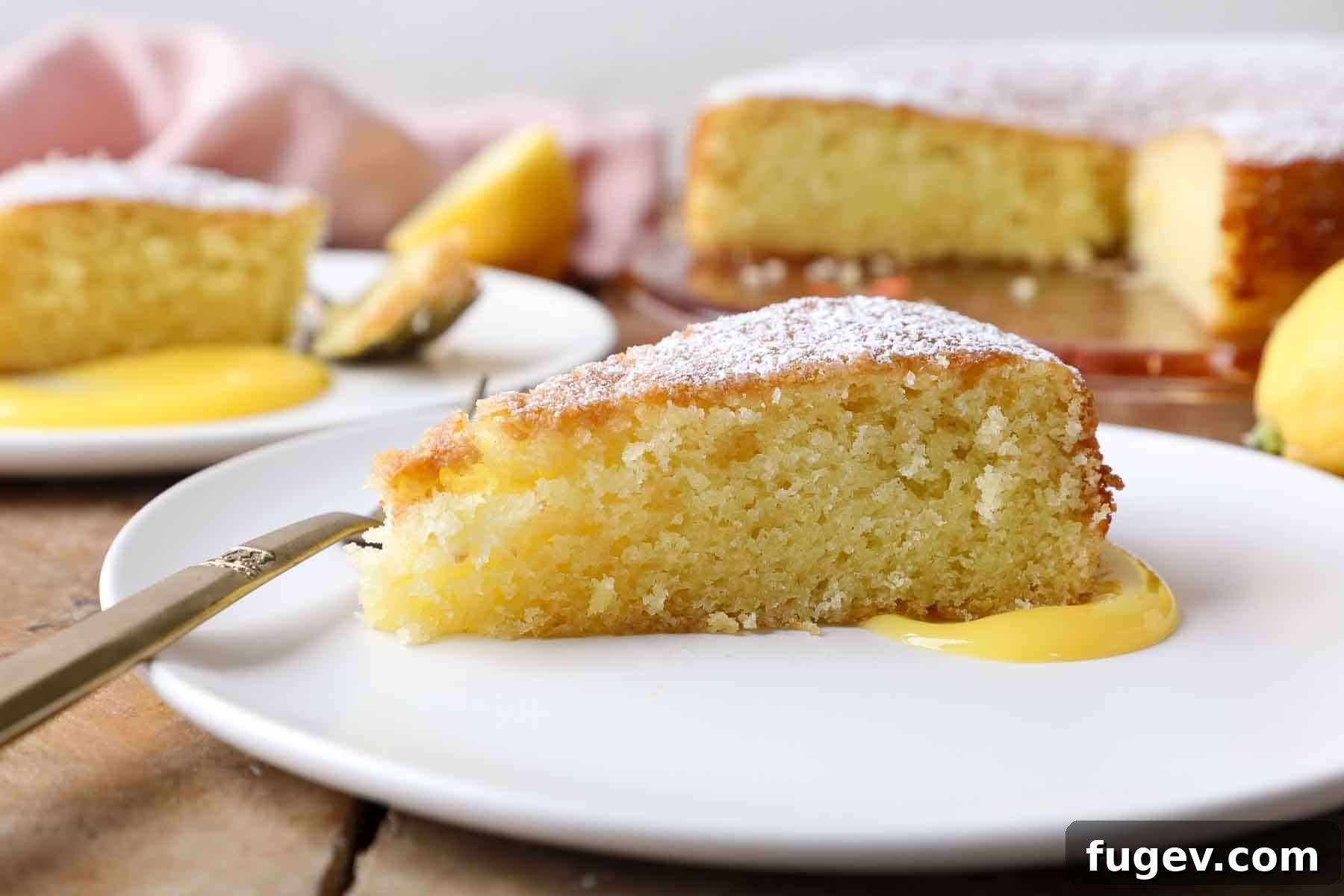Zesty Mediterranean Olive Oil Cake 5 side of a slice of lemon olive oil cake on white plate.