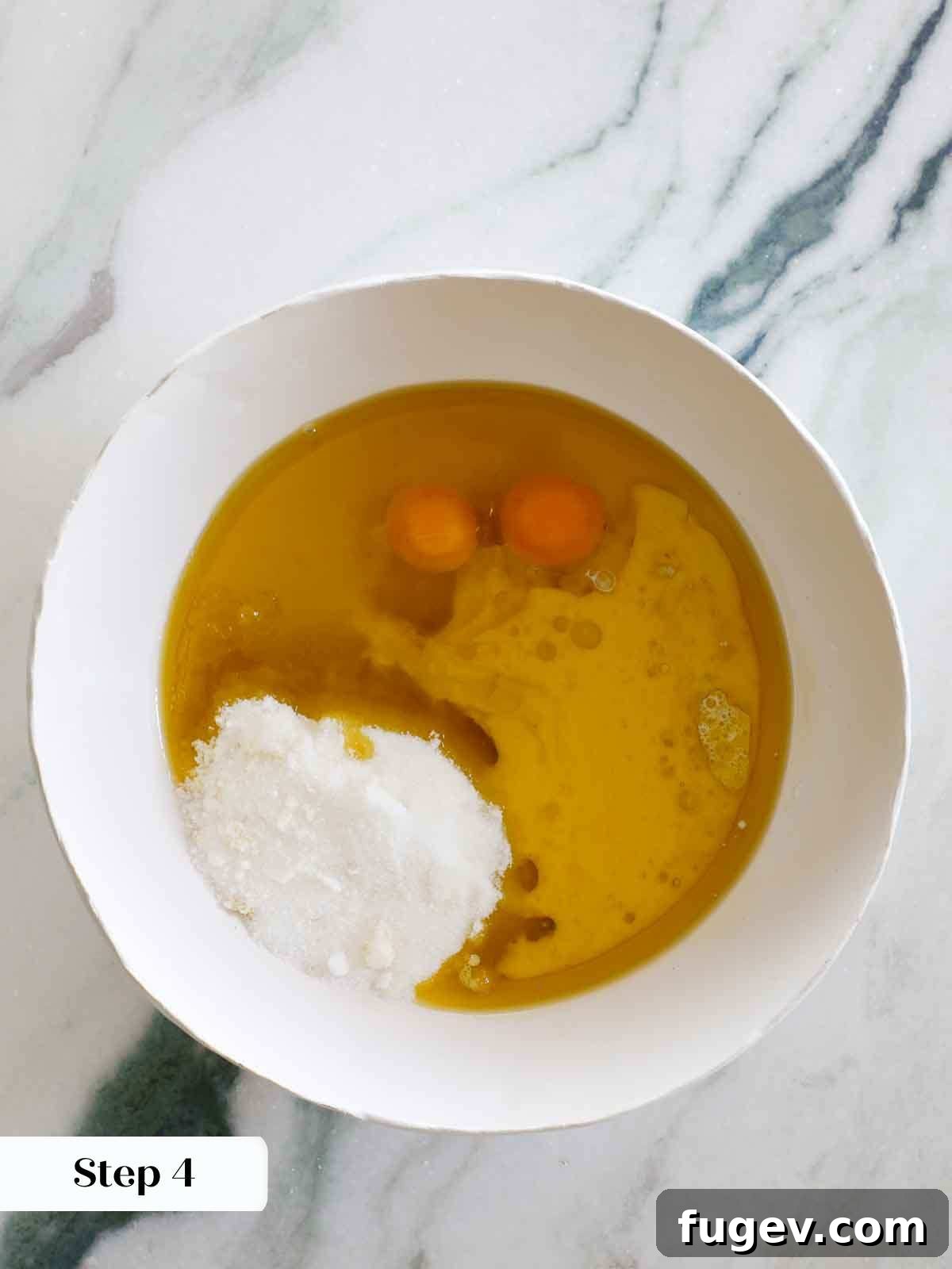 Zesty Mediterranean Olive Oil Cake 8 wet ingredients for olive oil cake in white mixing bowl.
