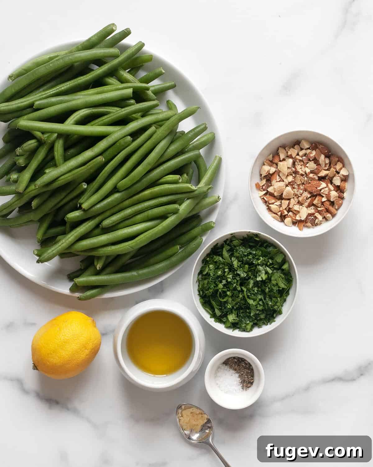 Smoky Green Beans with Bright Almond Gremolata 3 Ingredients for grilled green beans with almond gremolata including fresh green beans, lemon, parsley, almonds, garlic, and olive oil.