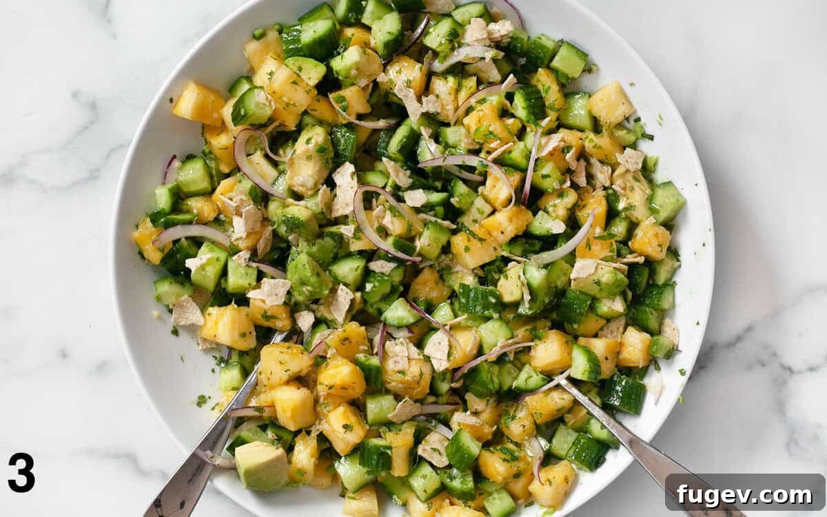 Refreshing Pineapple Cucumber Medley 5 A vibrant pineapple cucumber salad, perfectly tossed with its zesty lime dressing, presented in an elegant bowl on a rustic surface.
