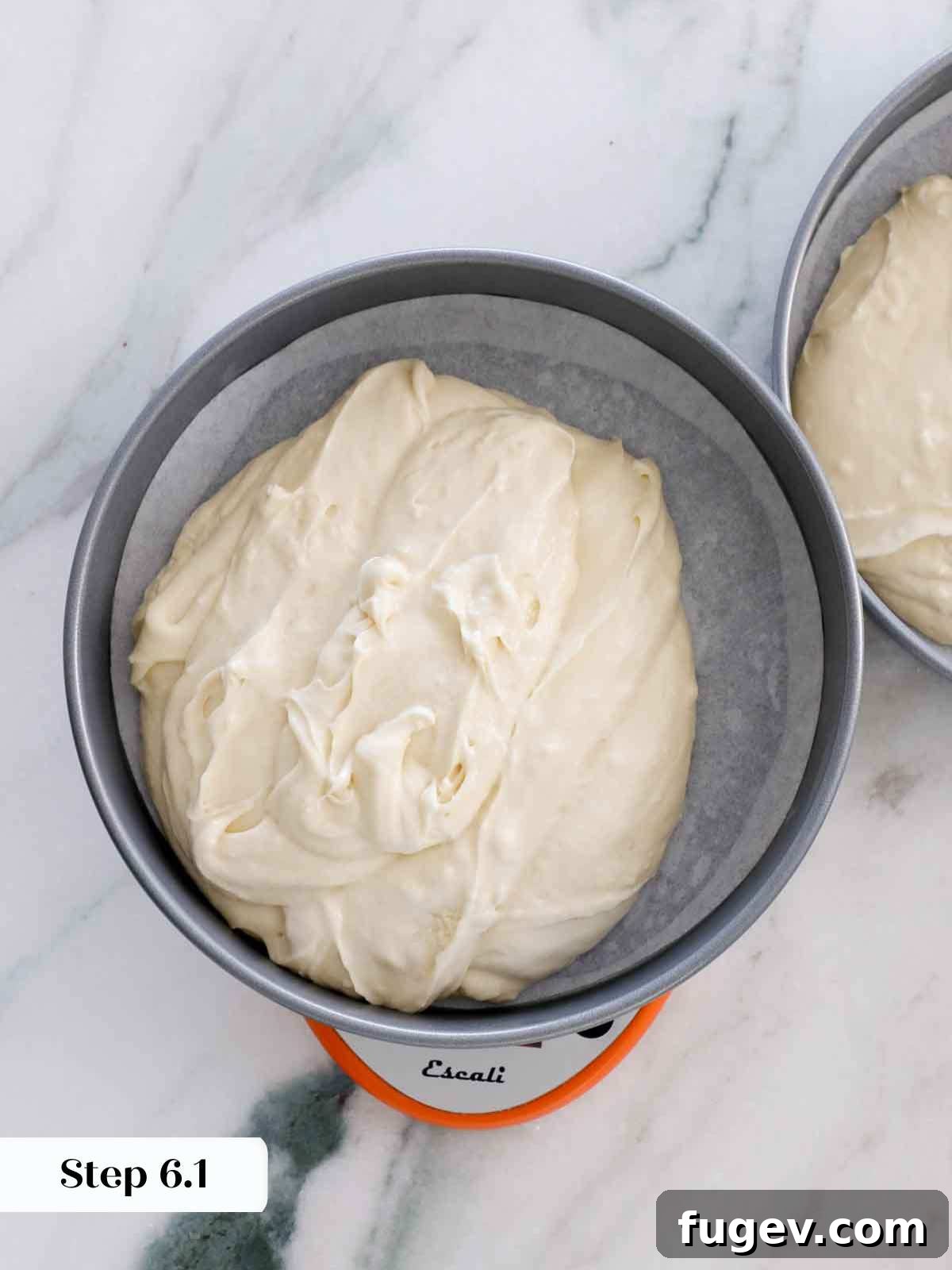 Velvet Vanilla Cake Recipe 14 Dividing vanilla cake batter precisely between two cake pans using a kitchen scale.